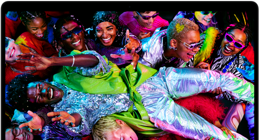 Colorful screen on a MacBook Pro of a person crowdsurfing at a party, showcasing the vibrant Liquid Retina XDR display
