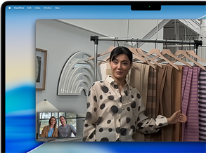 A video call on a MacBook Pro where a woman shows fabrics to two people on the call, with Center Stage keeping her centered in the frame as she moves around