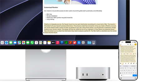 Mac mini front, tucked under Studio Display, an iPhone sits to the right of the device and the display, text selected with cut, copy, paste, and AutoFill commands above on iPhone matches highlighted text on display, showcasing Universal Clipboard