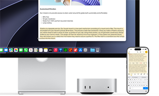 Mac mini front, tucked under Studio Display, an iPhone sits to the right of the device and the display, text selected with cut, copy, paste, and AutoFill commands above on iPhone matches highlighted text on display, showcasing Universal Clipboard